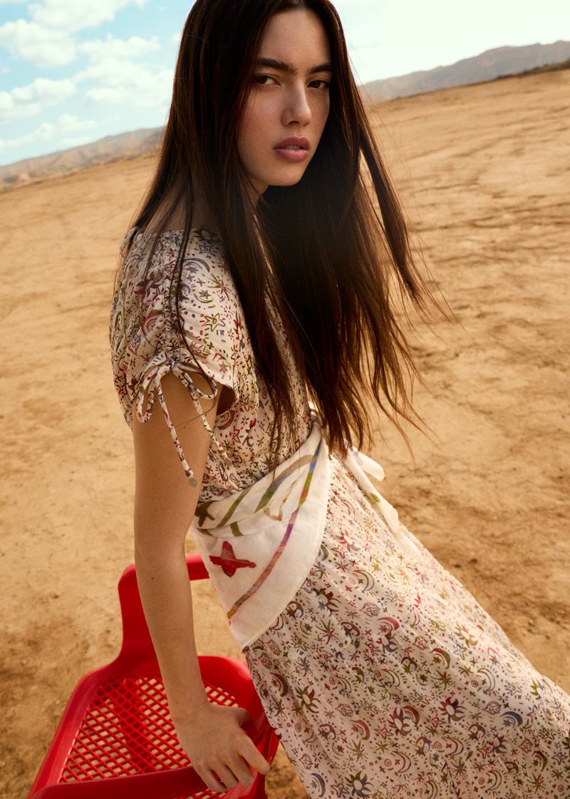 Model standing outside in sweatshirt, jeans and matching denim jacket.