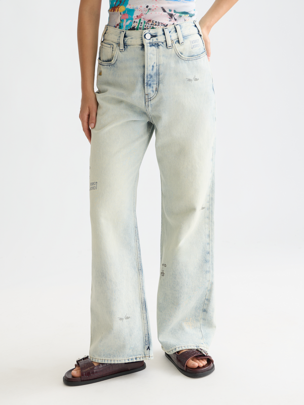 Person wearing light blue jeans on a white background