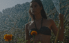 background image featuring female model in a swim top water flowers